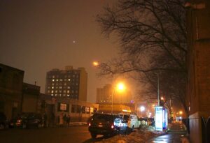 A surveillance camera (top right) affixed to a NYCHA building overlooks the intersection of 40th Avenue and 10th Street where Oyamada was killed (Ellen Moynihan / Gothamist)